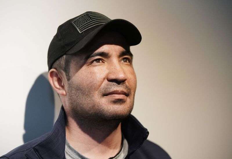 Afghan refugee Abdul, who is only providing his first
name since his family is still in Kabul, wears a hat with an
American flag at his home in Herriman on Thursday, Nov. 18.