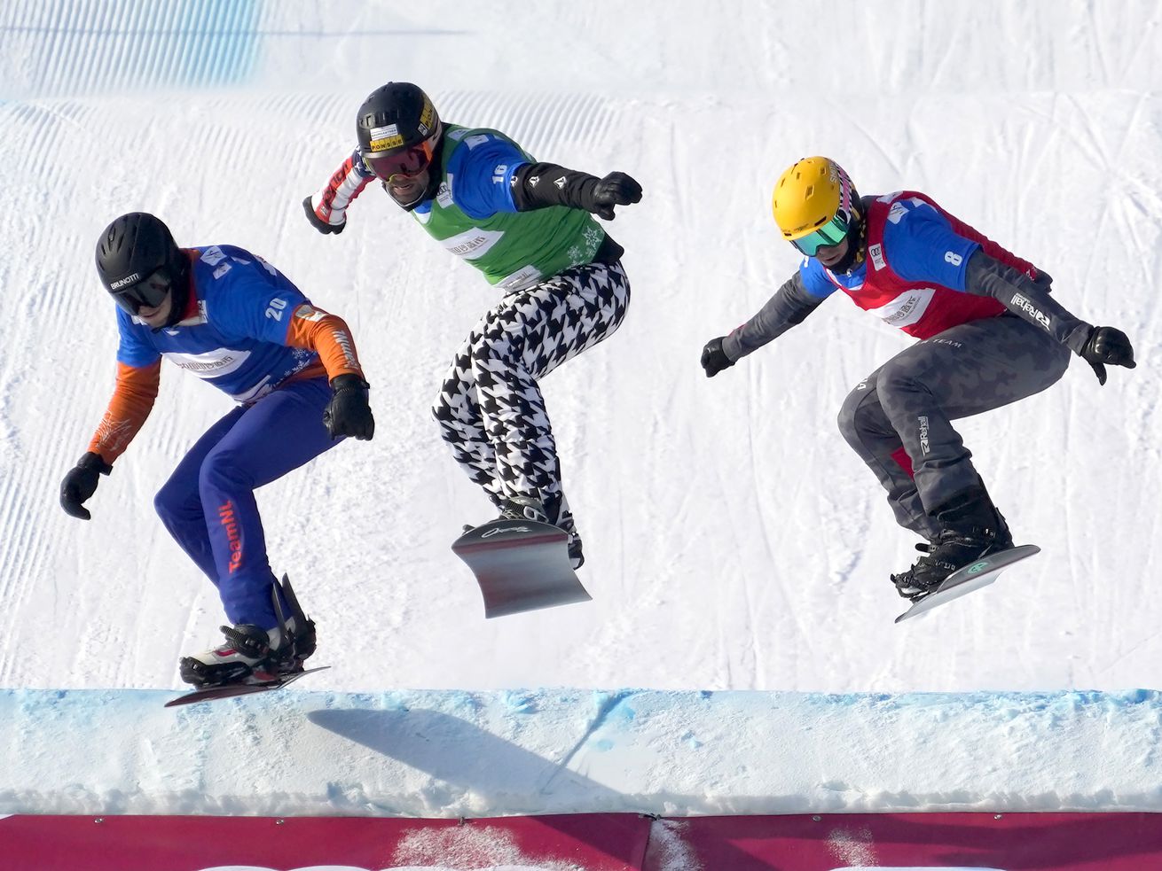 From left, Glenn de Blois of the Netherlands, Nick Baumgartner of the U.S., and Jakob Dusek of Austria compete during the FIS Snowboard Cross World Cup in Zhangjiakou, China on Sunday, Nov. 28. The U.S. has announced a diplomatic boycott of the upcoming 2022 Games in
China.