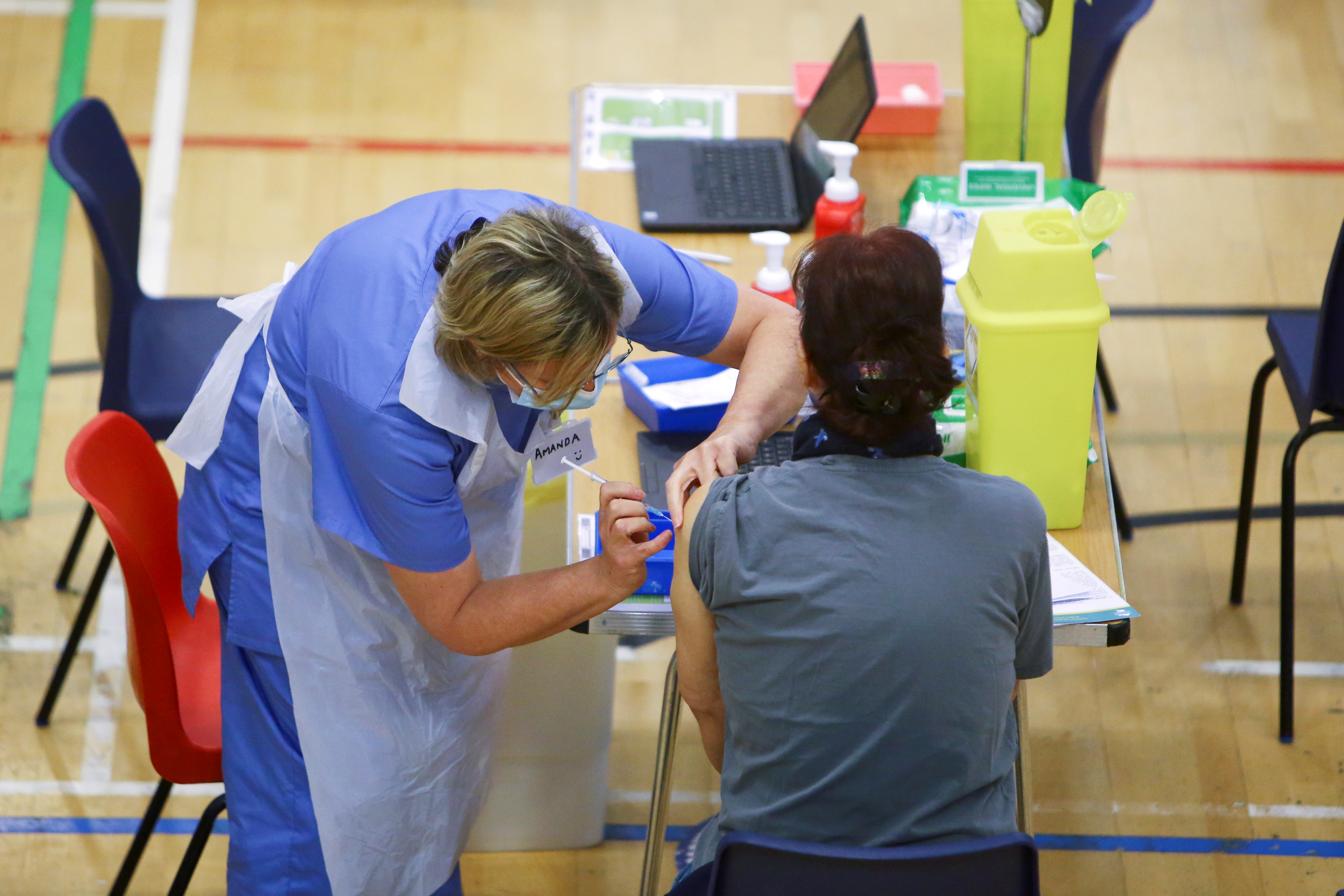A woman receives an Oxford-AstraZeneca coronavirus disease vaccine at a COVID-19 vaccination centre at Cwmbran Stadium in Cwmbran, South Wales, Britain Feb. 17. A professor of vaccinology says next pandemic could be more lethal than COVID-19.