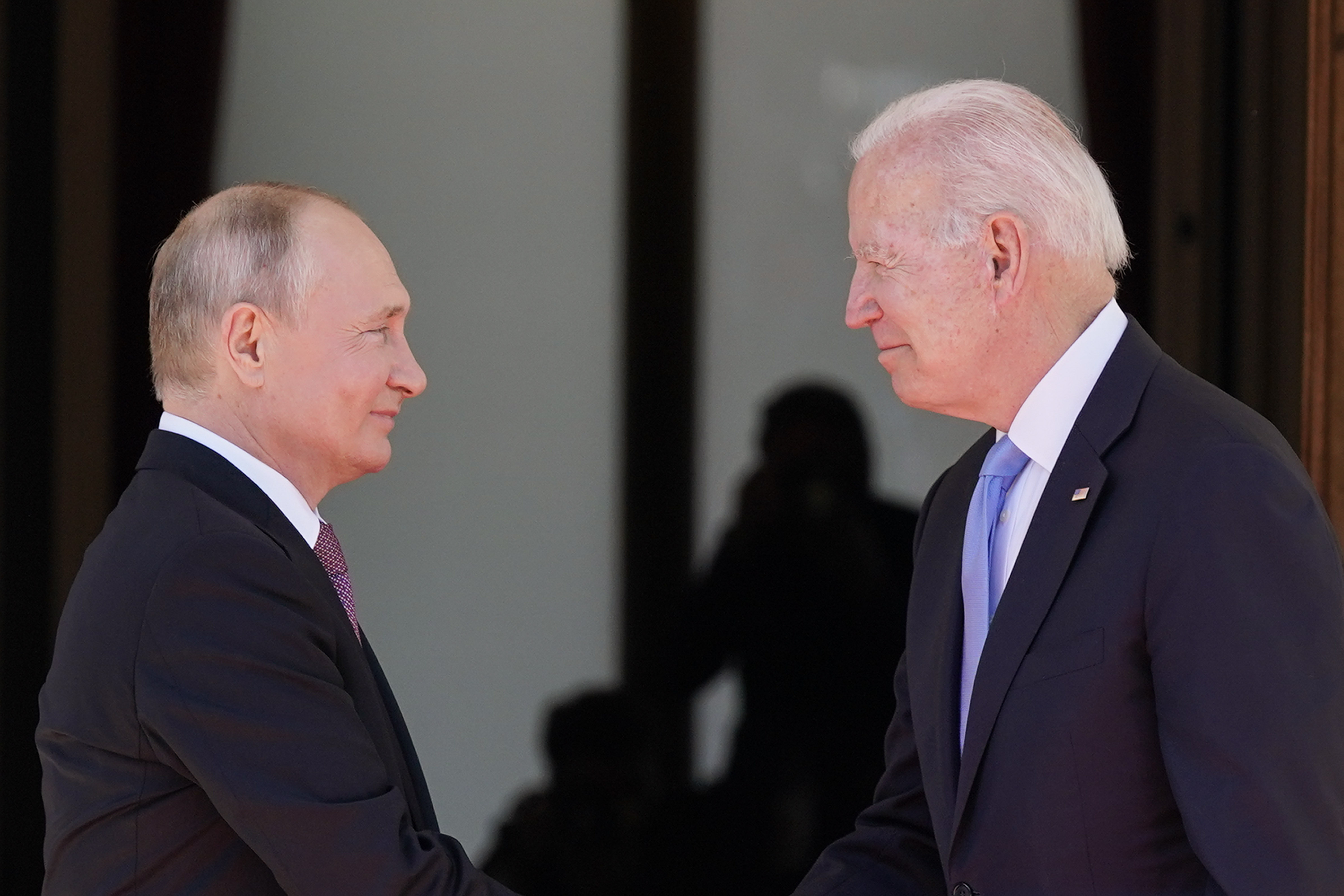 President Joe Biden and Russian President Vladimir Putin, arrive to meet in Geneva, Switzerland, June 16. Biden warns Putin in a video conference Tuesday that Russia could be hit with the toughest economic sanctions yet if it invades Ukraine.