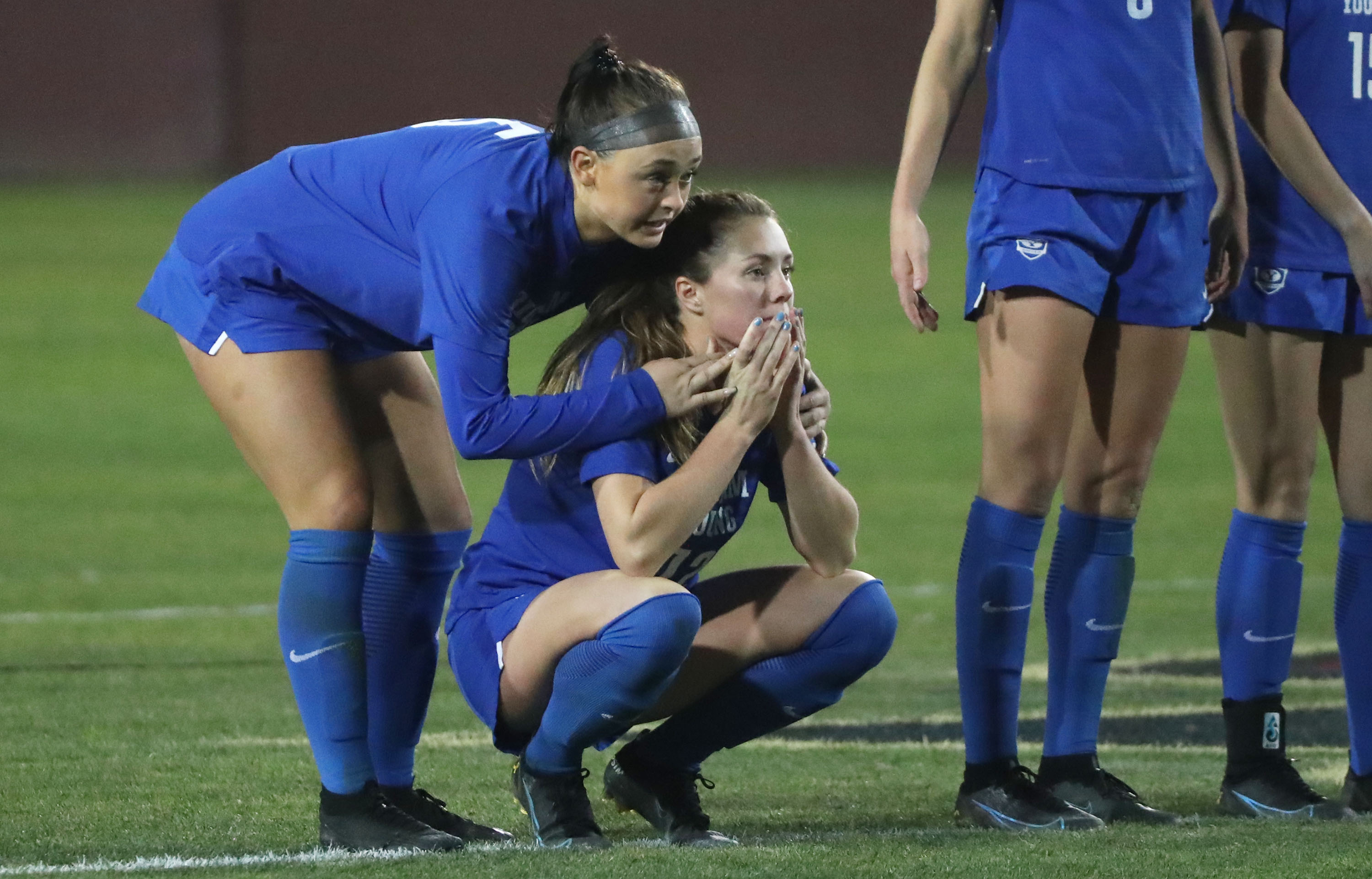 Brigham Young forward Brecken Mozingo (5) consoles Brigham Young midfielder Jamie Shepherd (12) after her penalty kick in overtime was blocked during the NCAA national soccer championship at Stevens Stadium at Santa Clara University in Santa Clara, California on Monday, Dec. 6, 2021. After losing in overtime, the now-No. 6 Cougars have been on a quest to get back to the College Cup.