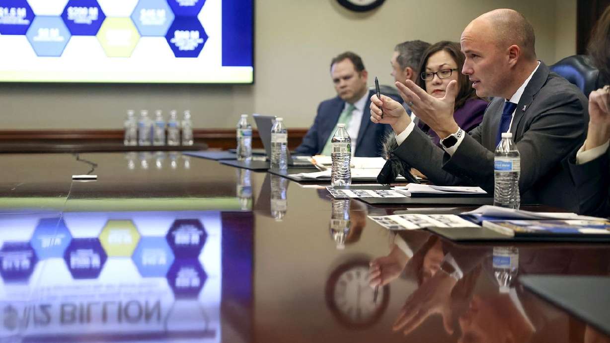 Gov. Spencer Cox, right, talks about state budget recommendations with the KSL and Deseret News editorial boards at the Deseret News office in the Triad Center in Salt Lake City on
Monday.