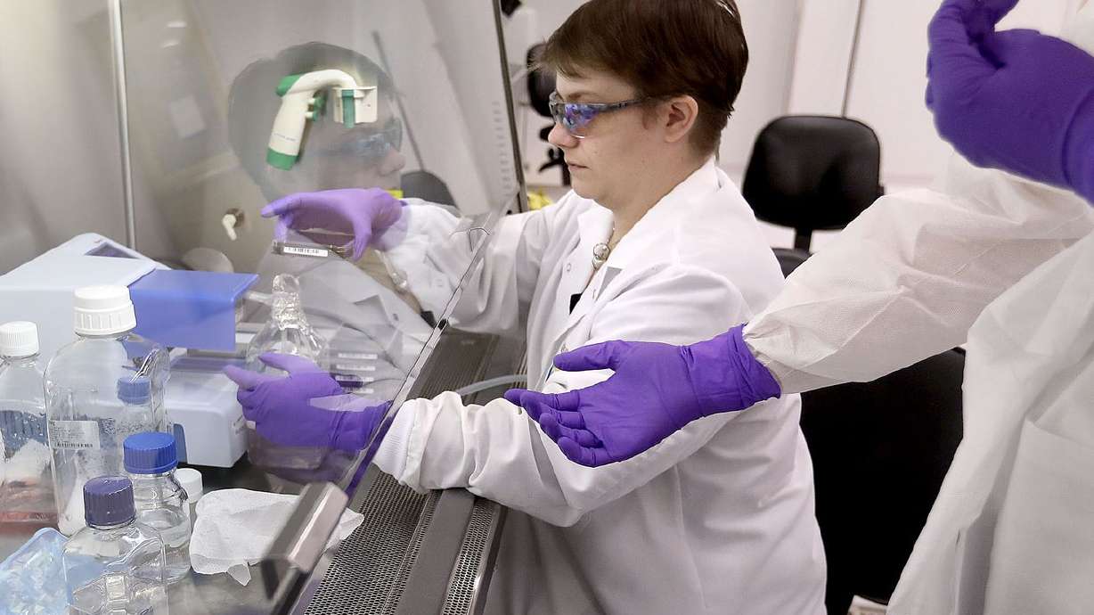 Lawrie Allred, an HTS engineer, hands a cell plate to a
co-worker while seeding cells at Recursion Pharmaceuticals at The
Gateway in Salt Lake City on Oct. 30, 2018.