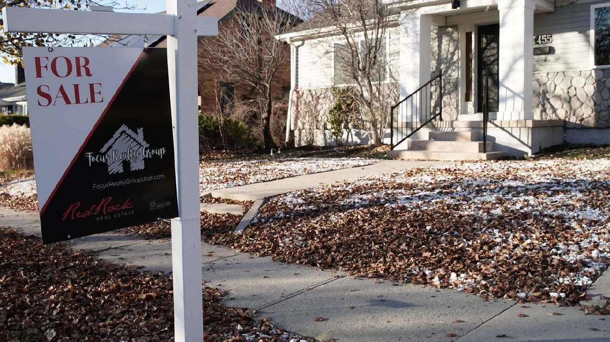 A "for sale” sign is displayed outside of a house in
the Sugar House neighborhood of Salt Lake City on Tuesday, Dec. 7,
2021.