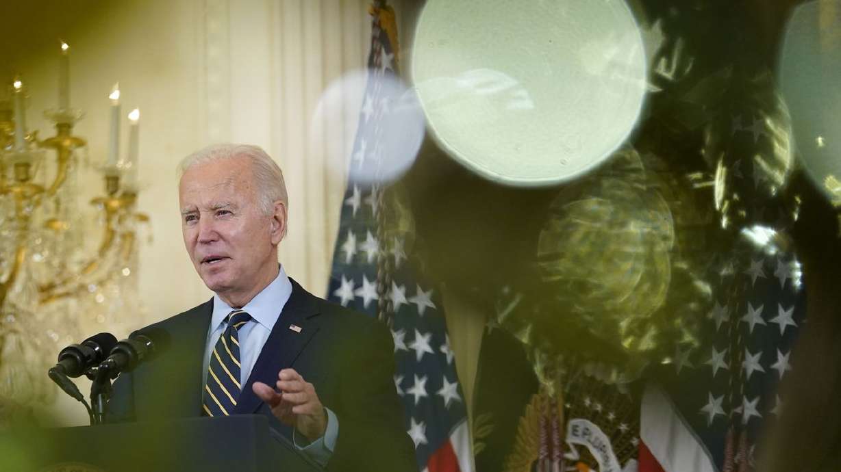 President Joe Biden, viewed through the branches of a
Christmas tree, speaks from the East Room of the White House in
Washington on Monday, Dec. 6, 2021, on his administration’s plans
to lower the costs of prescription drugs, letting Medicare
negotiate drug prices, capping how much seniors and people with
disabilities have to pay for drugs.