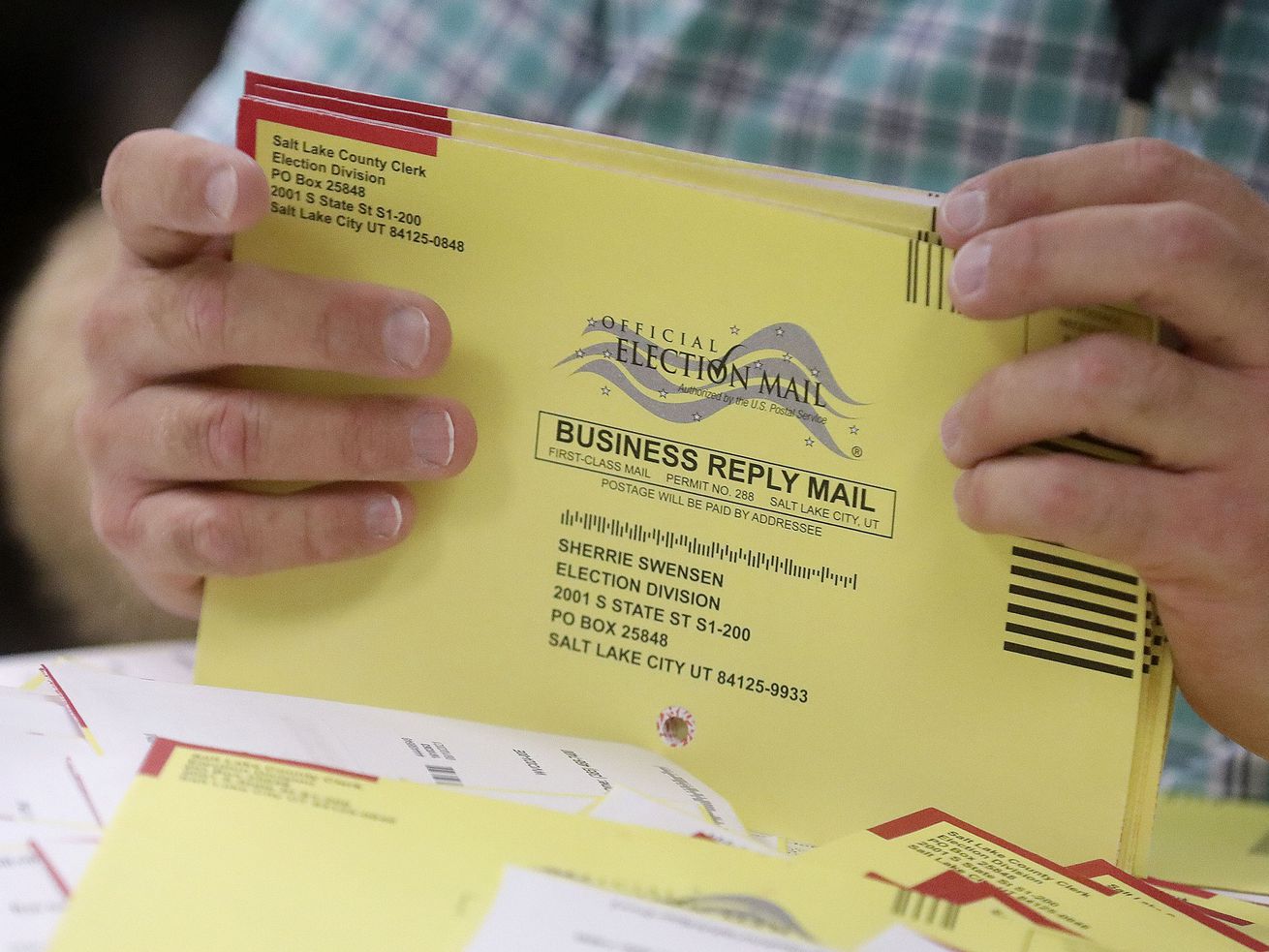 Elections coordinator Michael Fife gathers election envelopes in the Elections Management Center at the Salt Lake County Government Center in Salt Lake City on Tuesday, Aug. 10.