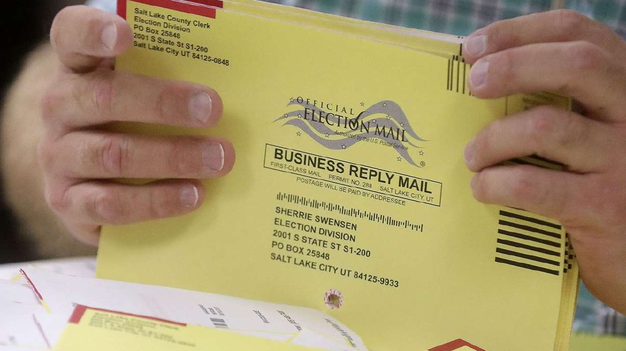 Elections coordinator Michael Fife gathers election envelopes in the Elections Management Center at the Salt Lake County Government Center in Salt Lake City on Tuesday, Aug. 10.
