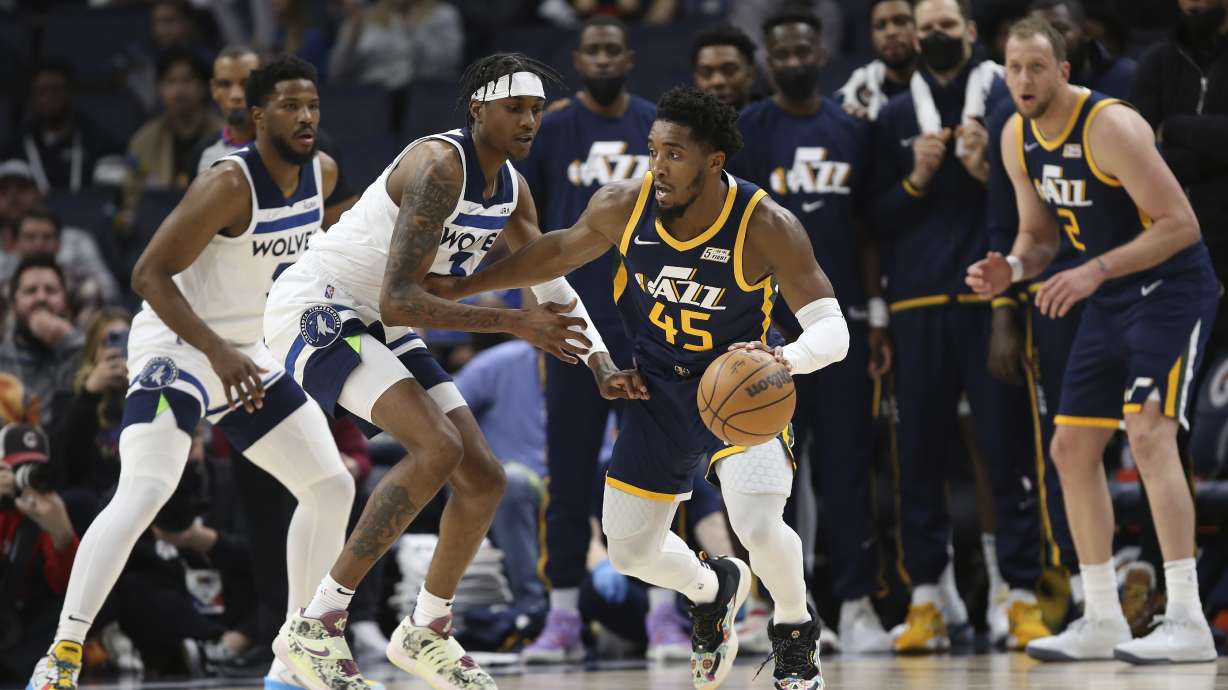 Utah Jazz guard Donovan Mitchell (45) handles the ball against Minnesota Timberwolves forward Jaden McDaniels (3) during the second half of an NBA basketball game Wednesday Dec. 8, 2021, in Minneapolis. Utah won 136-104.