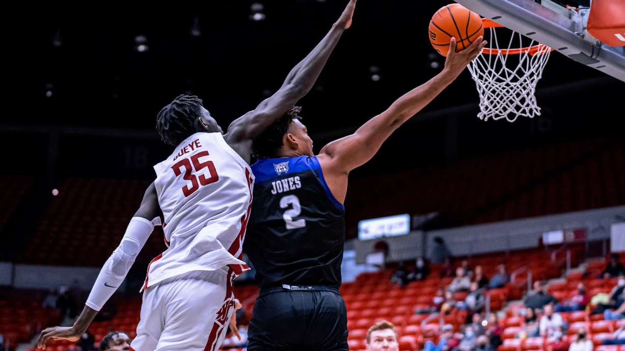 Weber State forward Dillon Jones (2) scoops layup past Washington State's Mouhamed Gueye (35) in 94-60 loss on Dec. 8, 2021.