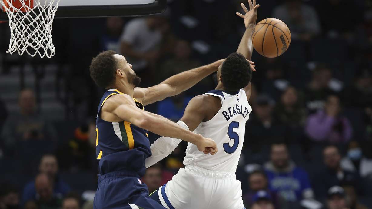 Utah Jazz center Rudy Gobert (27) knocks the ball out away from Minnesota Timberwolves guard Malik Beasley (5) during the first half of an NBA basketball game Wednesday Dec. 8, 2021, in Minneapolis.