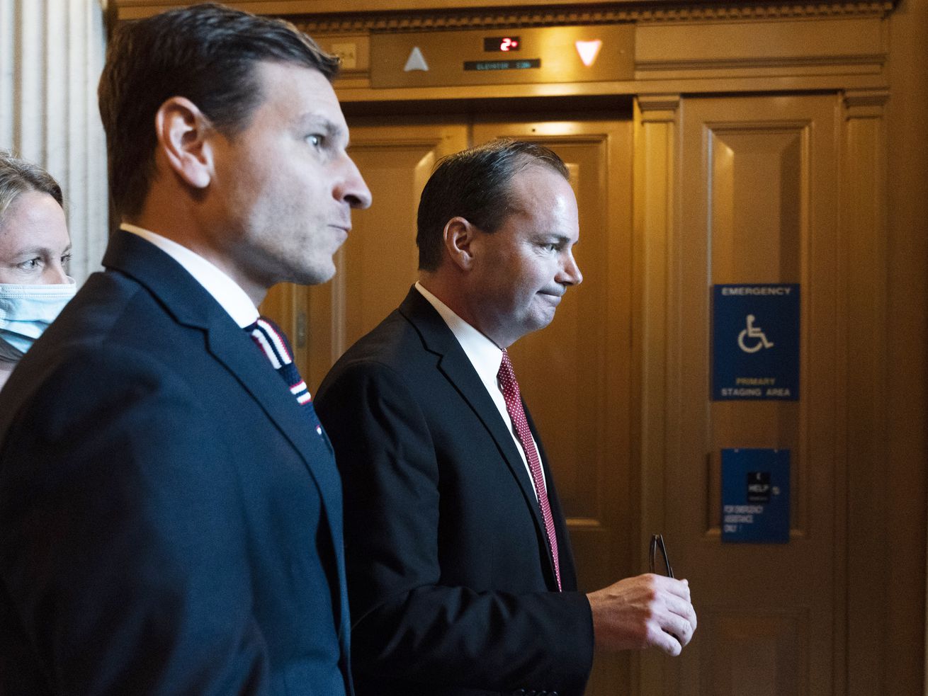 Sen. Mike Lee, R-Utah, right, walks to a luncheon for Senate Republicans on Dec. 2, on Capitol Hill in Washington. Two centrists Democrats joined all 50 Republicans, including Lee and Utah Sen. Mitt Romney, in approving a measure to scrap President Joe Biden’s federal vaccine mandate.