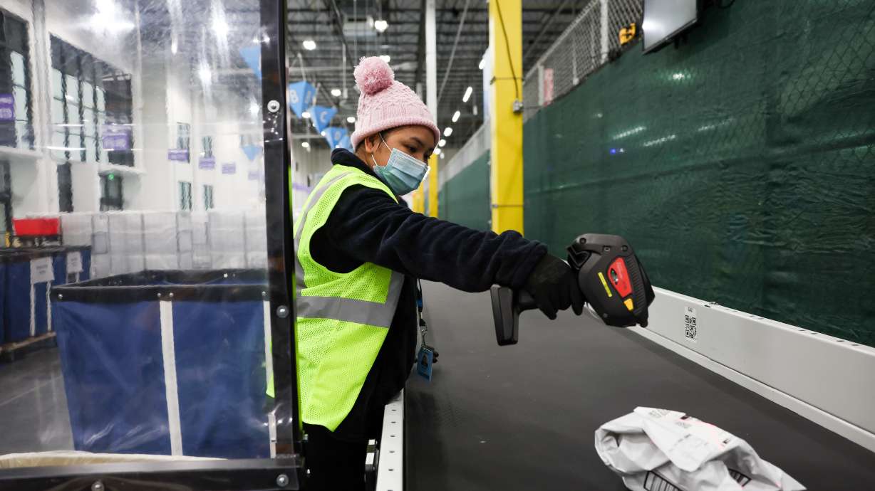 Htoo Pow scans outgoing packages at Amazon’s new sub same-day fulfillment center, dubbed SUT1, in Salt Lake City on Thursday. Once fully ramped up in February, the facility will be able to deliver packages to homes along a portion of the Wasatch Front within 5 hours of the time of ordering.