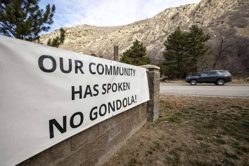 A sign opposed to a gondola is pictured near the mouth
of Little Cottonwood Canyon in Cottonwood Heights on Tuesday.