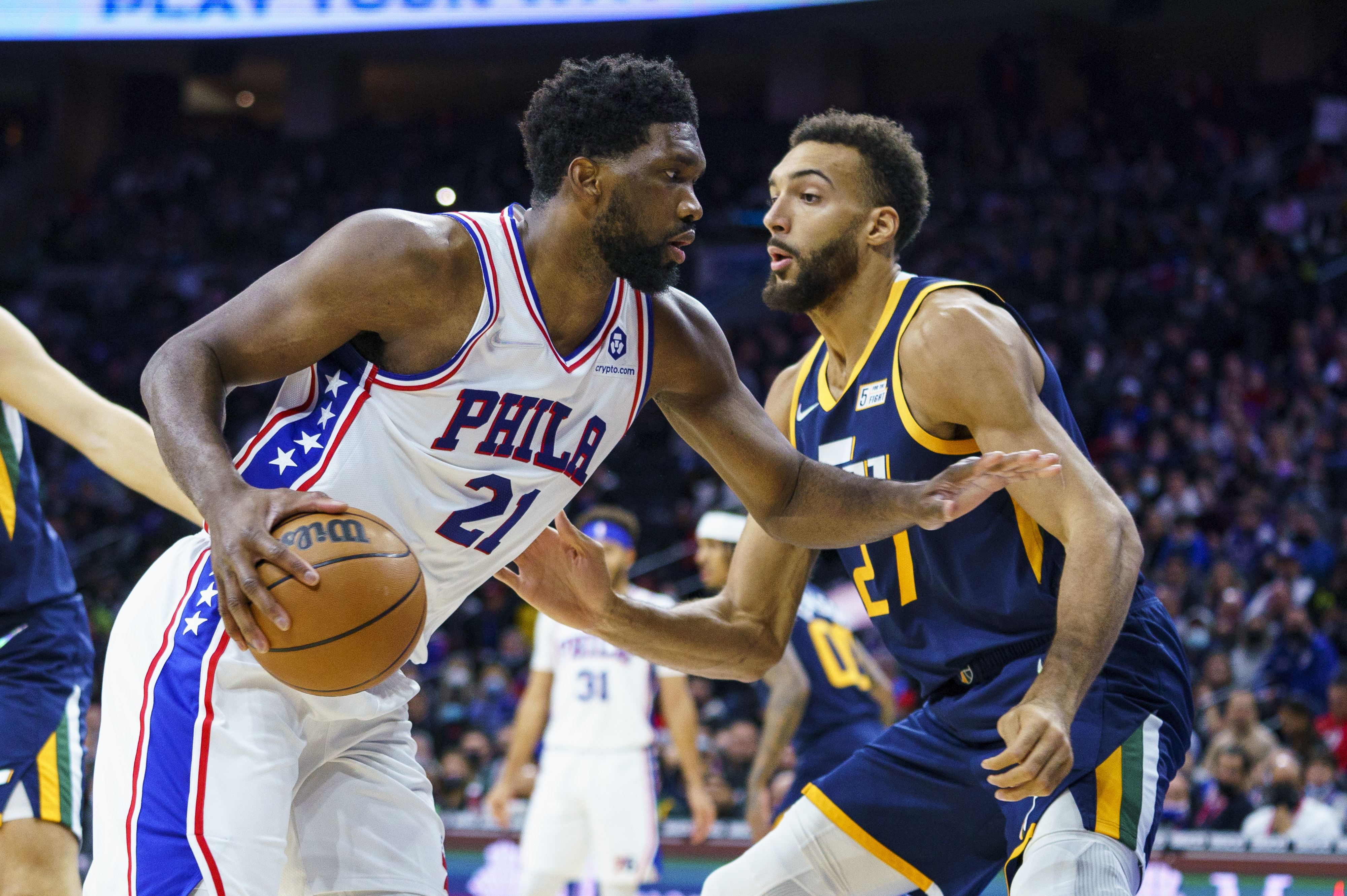 Philadelphia 76ers' Joel Embiid, left, moves against Utah Jazz's Rudy Gobert, right, during the first half of an NBA basketball game, Thursday, Dec. 9, 2021, in Philadelphia.