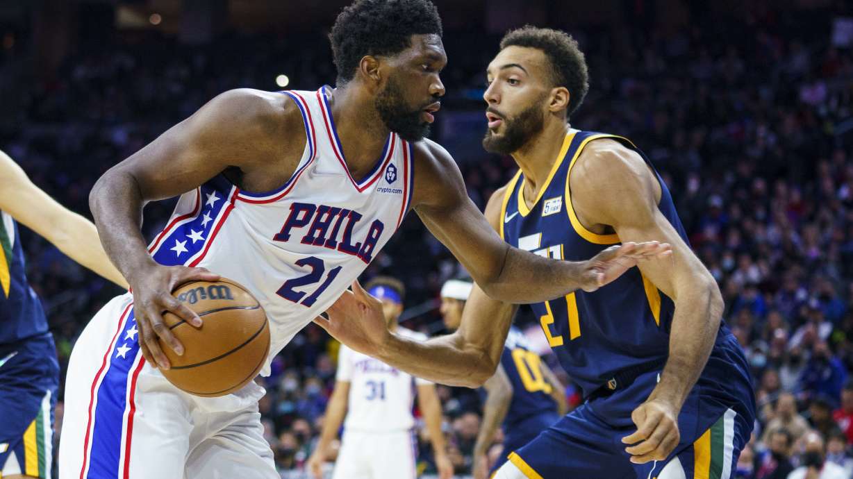 Philadelphia 76ers' Joel Embiid, left, moves against Utah Jazz's Rudy Gobert, right, during the first half of an NBA basketball game, Thursday, Dec. 9, 2021, in Philadelphia.