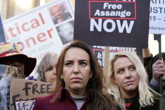 Stella Moris, fiancée of Julian Assange, stands with protestors in front of the High Court in London, Friday. A British appellate court has opened the door for WikiLeaks founder Julian Assange to be extradited to the United States.