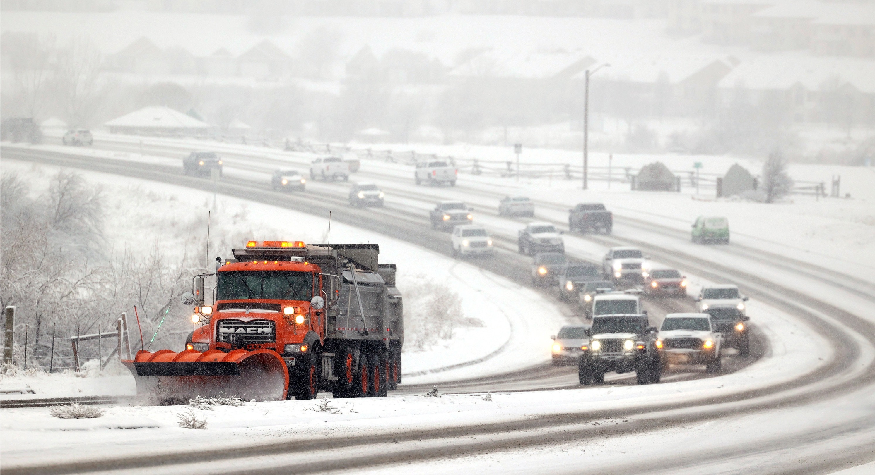 A snow plow clears 12300 South in Riverton during a snowstorm on Dec. 10, 2022.