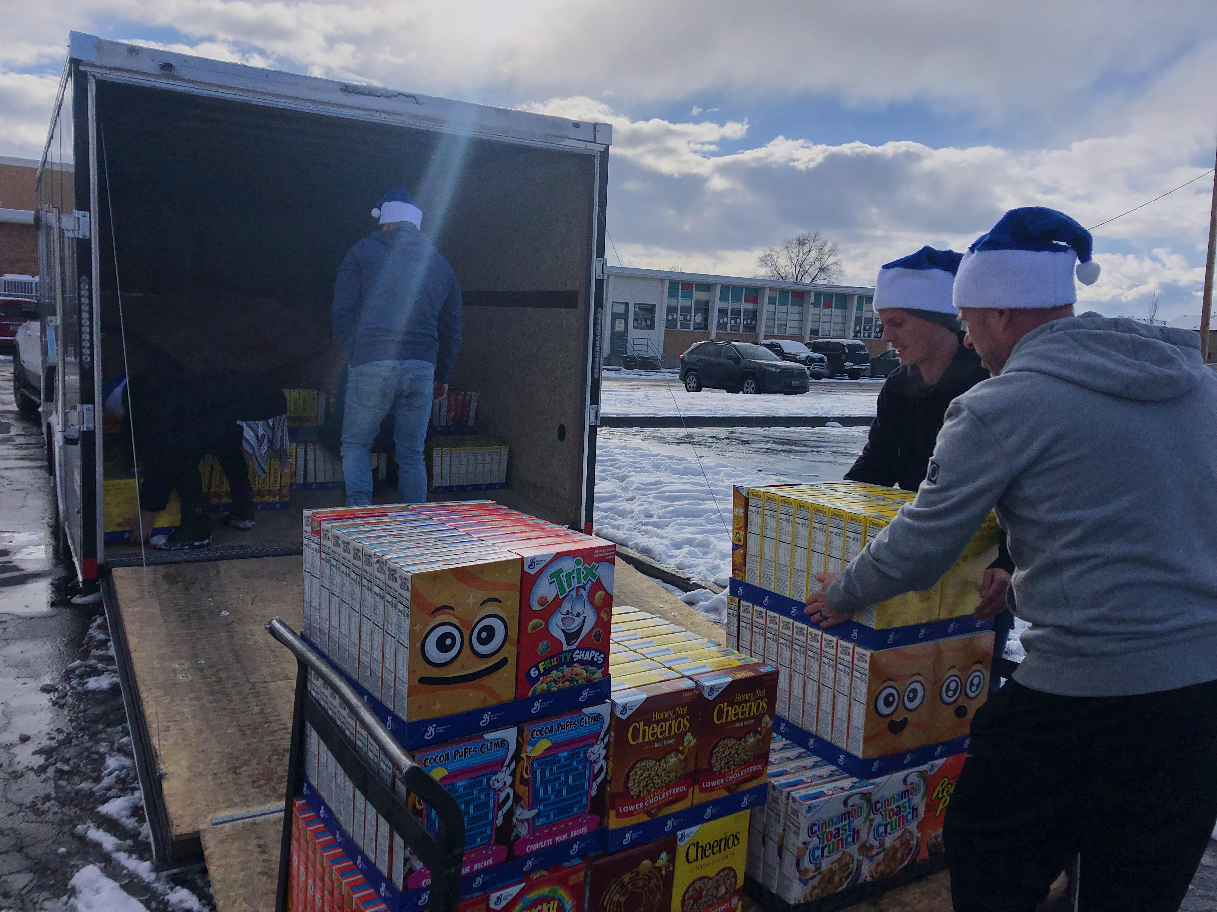 Brett Child and Bryan Doom unload cereal boxes at Lincoln Elementary School on Friday, Dec. 10. Lendio donated a total of 2,600 boxes of cereal between Lincoln, Woodrow Wilson and James E. Moss elementary schools.