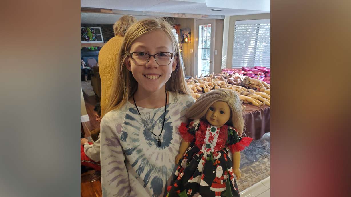 Addy Shorr, 13, poses with an American Girl doll and one of the doll outfits, which she made. Addy is working to help at least 100 girls in foster care feel a little more at home with a very special gift: their own American Girl doll.