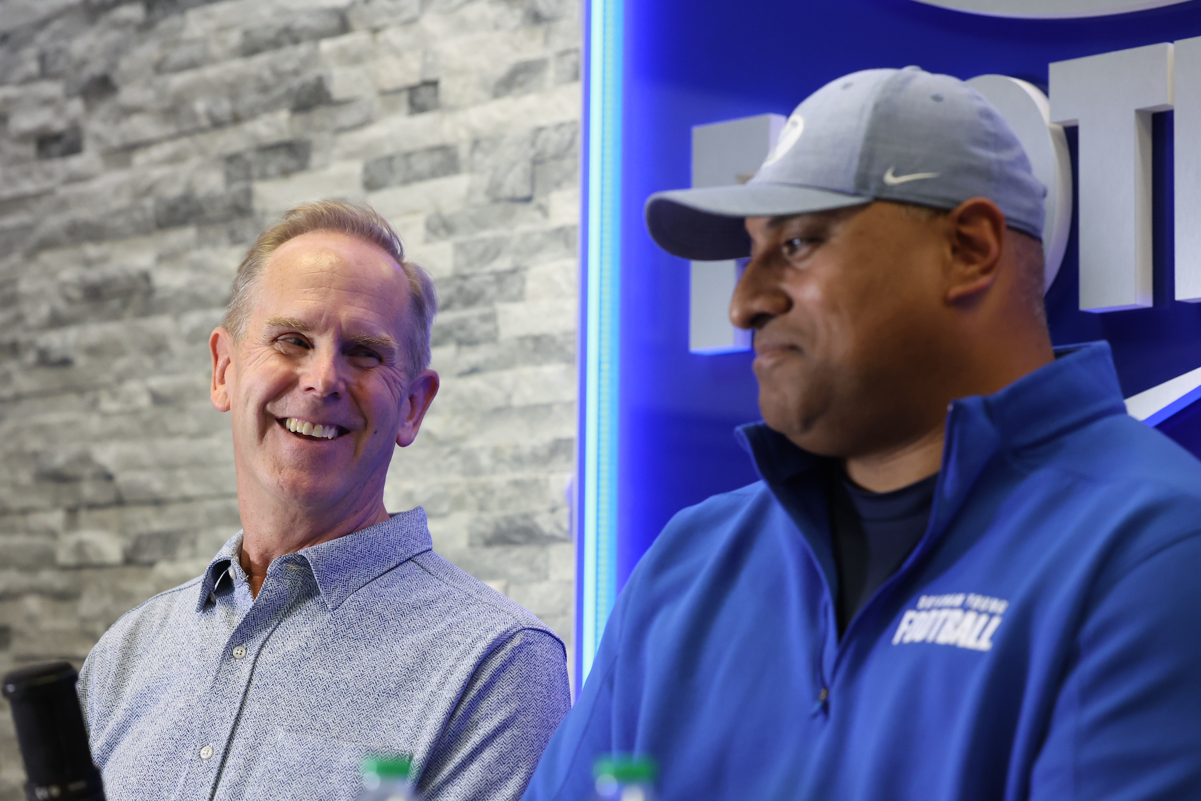 BYU athletic director Tom Holmoe, left, laughs with BYU coach Kalani Sitake after the Cougars announced a contract extension through the 2027 season, Friday, Dec. 10, 2021 in Provo.