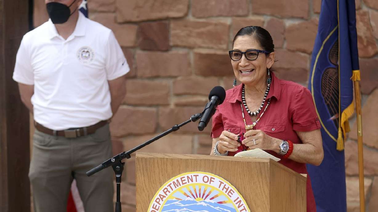 Gov. Spencer Cox, left, listens as Interior Secretary
Deb Haaland speaks during a press conference at Edge of the Cedars
Park Museum in Blanding on April 8, 2021.