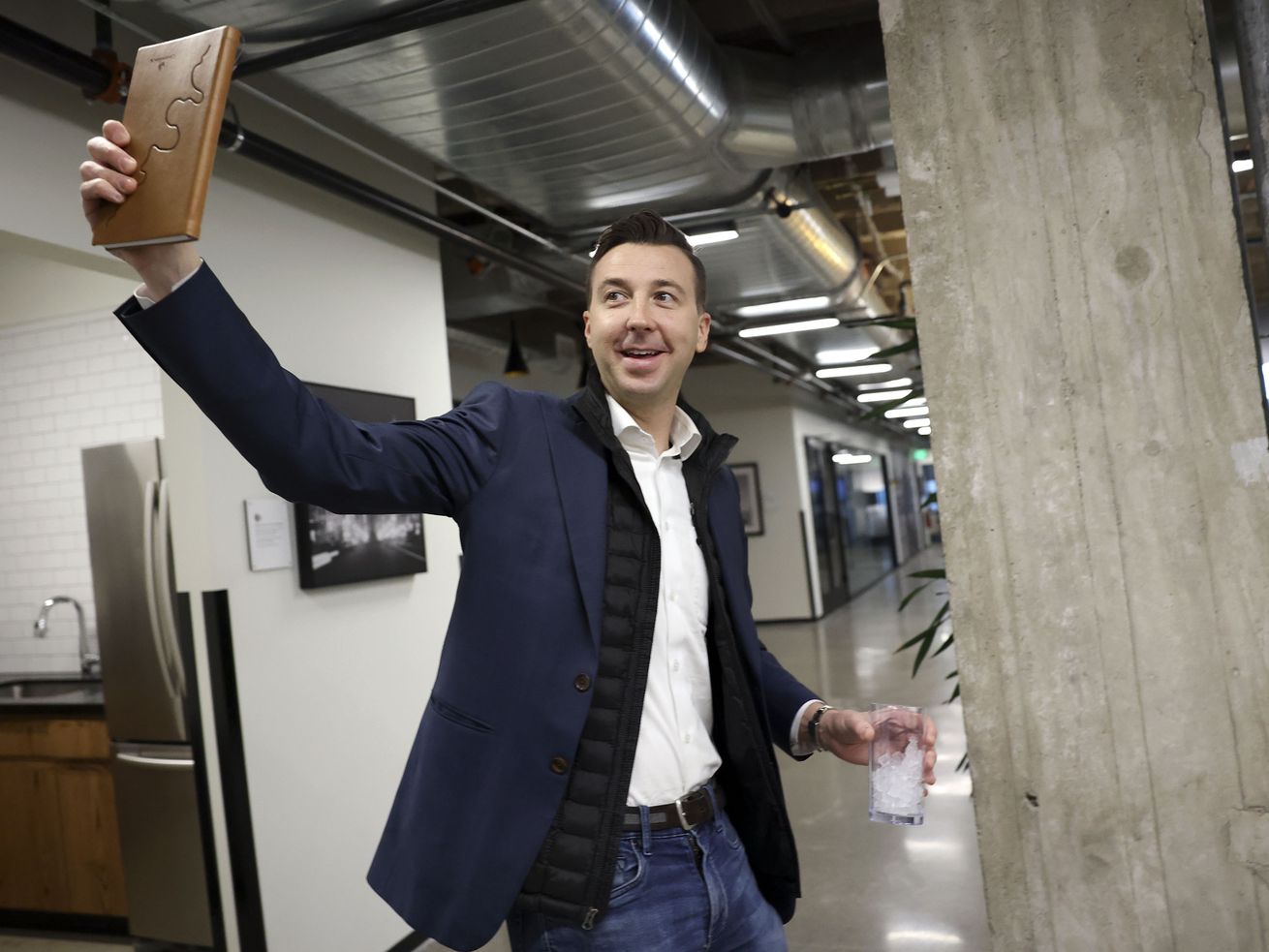 Ryan Westwood, Simplus CEO, waves to an employee while
walking back to his office at in Salt Lake City on Thursday.