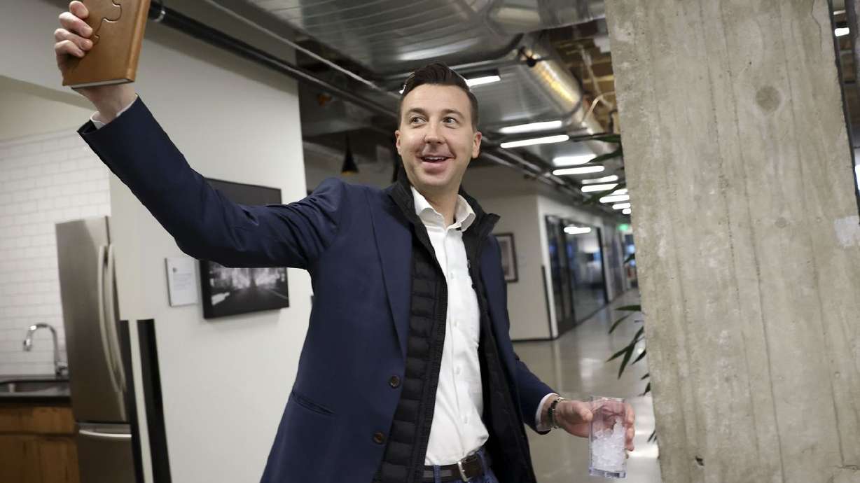 Ryan Westwood, Simplus CEO, waves to an employee while
walking back to his office at in Salt Lake City on Thursday.