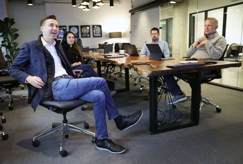 Ryan Westwood, Simplus CEO, left, Amy Cook, Simplus
chief marketing officer, Ryan Northington, Simplus vice president
of North American delivery, and Lance Evanson, Simplus chief
strategy officer, meet at the company’s office in Salt Lake City on
Thursday.