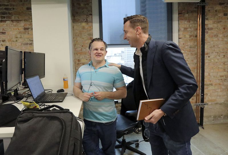 Ryan Westwood, Simplus CEO, right, talks with Shane
Howard, Simplus global operations officer, at the company’s office
in Salt Lake City on Thursday.