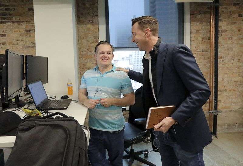 Ryan Westwood, Simplus CEO, right, talks with Shane
Howard, Simplus global operations officer, at the company’s office
in Salt Lake City on Thursday.