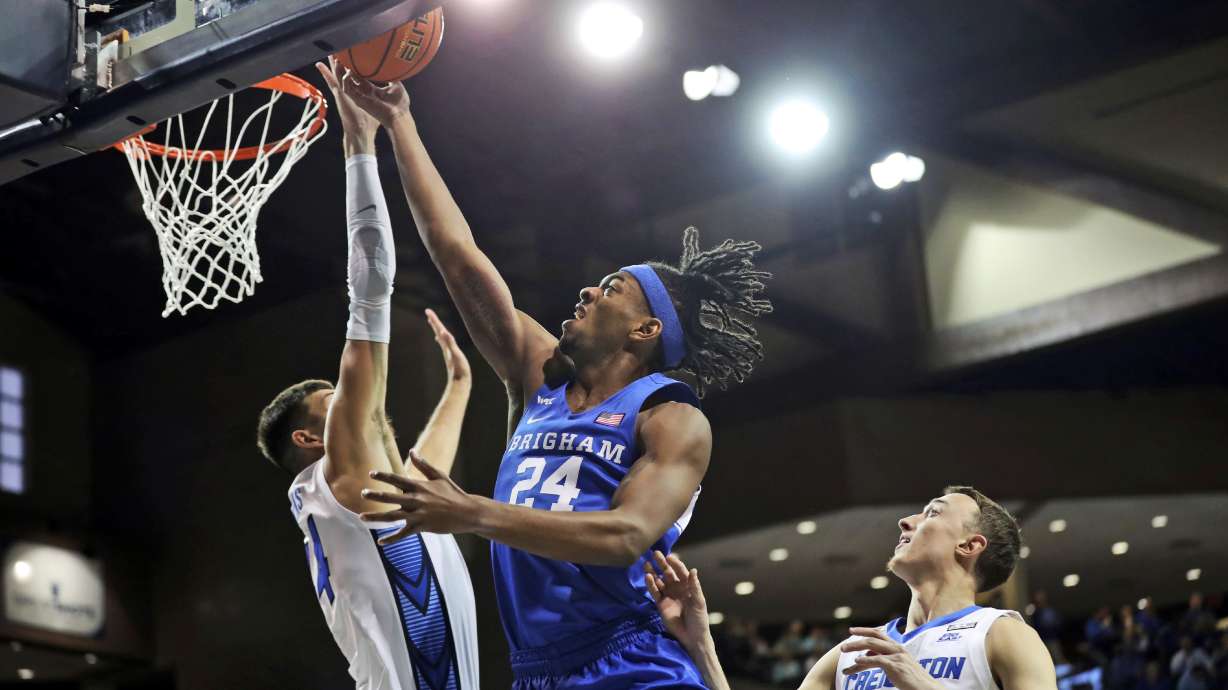 BYU Forward Seneca Knight (24) puts up a lay-up against a Creighton defender during an NCAA college basketball game Saturday, Dec. 11, 2021, in Sioux Falls, S.D.
