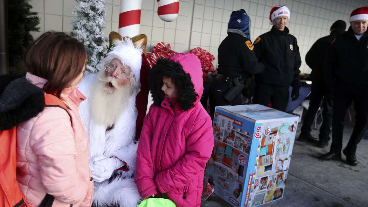 Sisters Camille and Jennifer Norton talk to Santa Dallas Nessen at the Salt Lake City Police Department’s annual holiday Police Pay-it-Forward event at Walmart in Salt Lake City on Saturday. Fifty-five children completed a holiday wish list and sent it to the Salt Lake City Police Department and the community outreach team shopped for each of the children and wrapped the gifts.