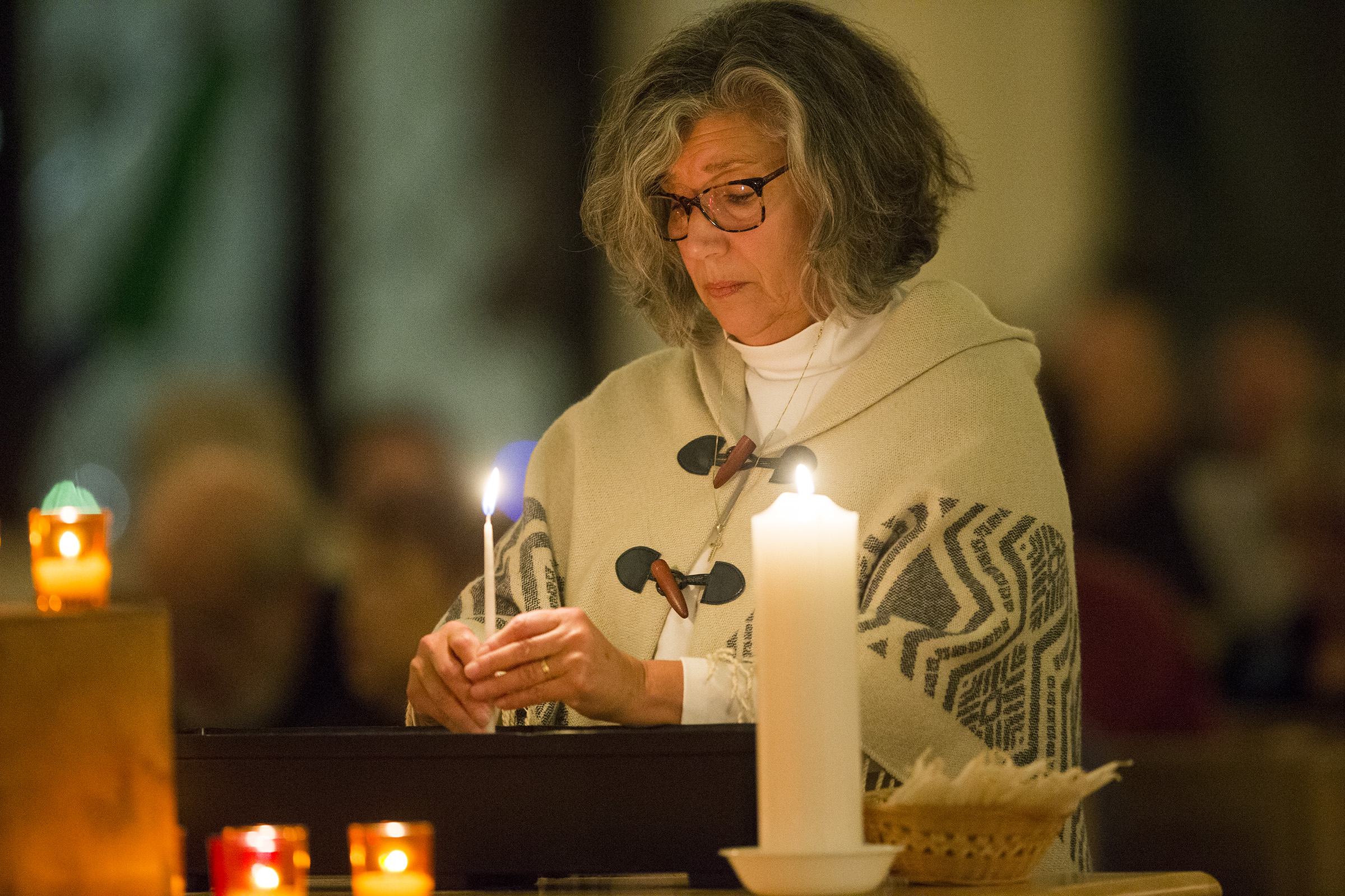 Alison Desiderio Peterson lights a candle during a vigil at All Saints Episcopal Church in Salt Lake City on Sunday, Dec. 10, 2017, to mark the fifth anniversary of the shooting at Sandy Hook Elementary School in Newtown, Conn. This year the vigil will be held again this time at the Community of Grace Presbyterian Church. 