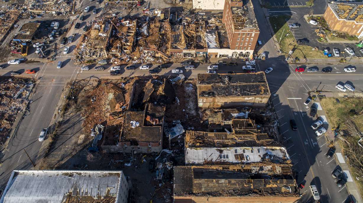 In this photo taken by a drone, buildings are demolished in downtown Mayfield, Ky., on Saturday, after a tornado traveled through the region Friday night.