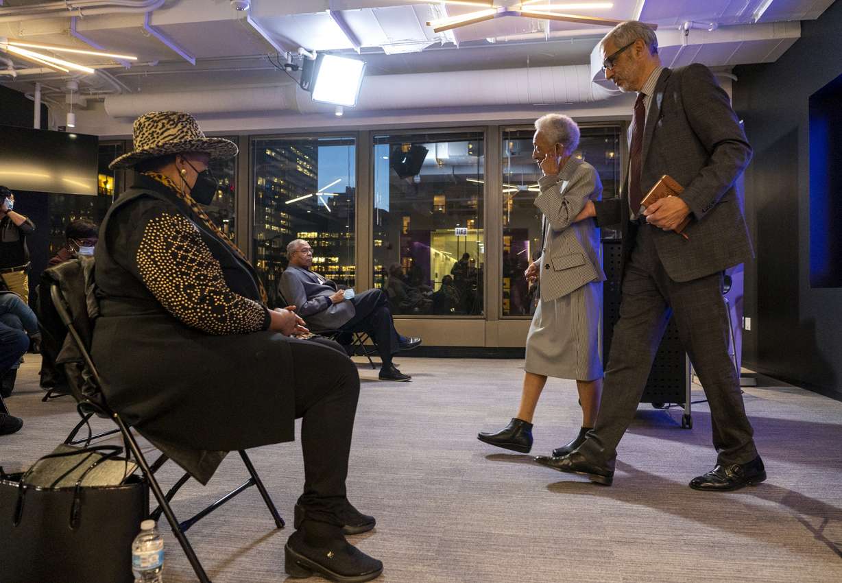 Thelma Wright Edwards, cousin of Emmett Till, is helped back to her seat by Northwestern University Professor Christopher Benson, during a press conference at Northwestern's Medill School of Journalism where members of Till's family commented on the final investigation report of his murder, Monday, Dec. in Evanston, Ill. The U.S. Justice Department said Monday it is ending its investigation into the 1955 lynching of Till, the Black teenager from Chicago who was abducted, tortured and killed after witnesses said he whistled at a white woman in Mississippi.