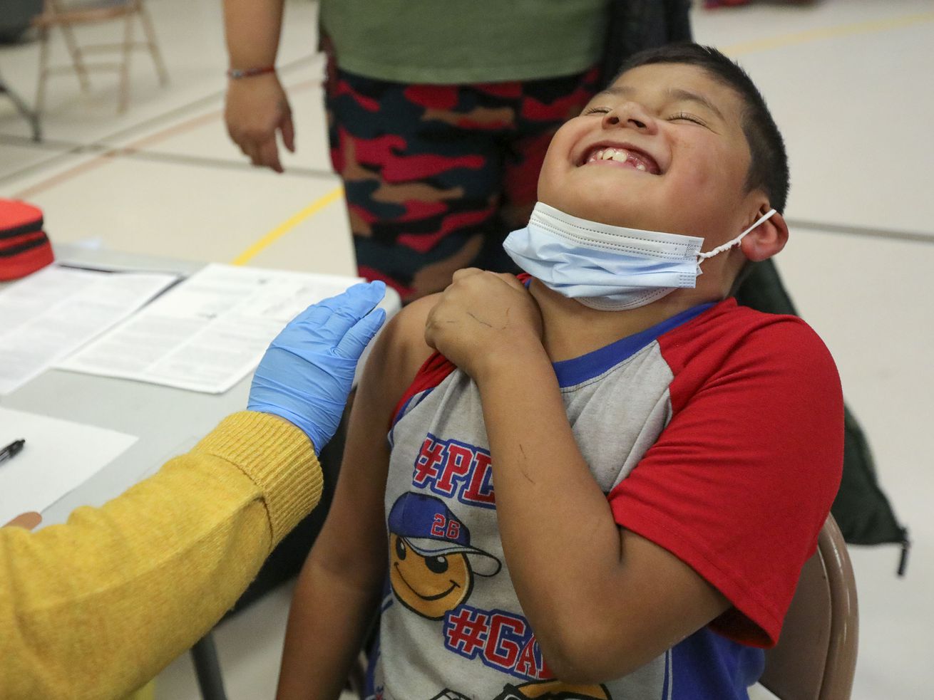 Angel Aguilar, 8, laughs before getting a COVID-19 vaccination at Hillsdale Elementary School in West Valley City on Nov. 8.