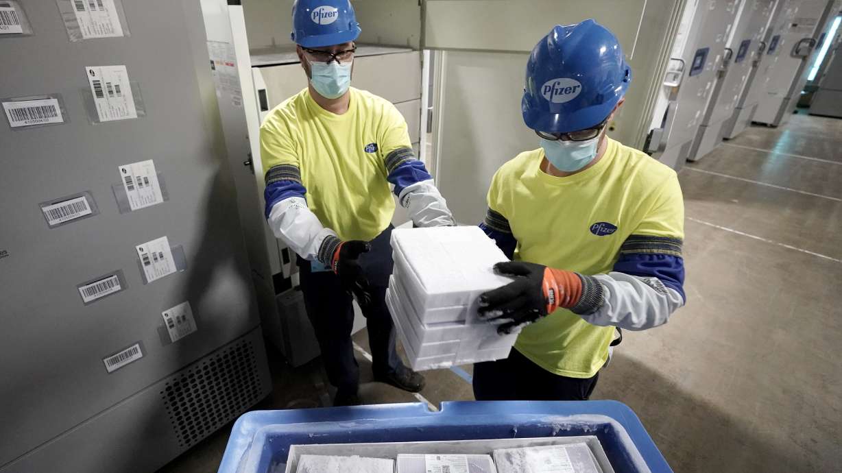 Boxes containing the Pfizer COVID-19 vaccine are prepared to be shipped at the Pfizer Global Supply Kalamazoo manufacturing plant in Portage, Mich., Dec. 13, 2020. The nation’s COVID-19 death toll stands at around 800,000 as the anniversary of the U.S. vaccine rollout arrives.