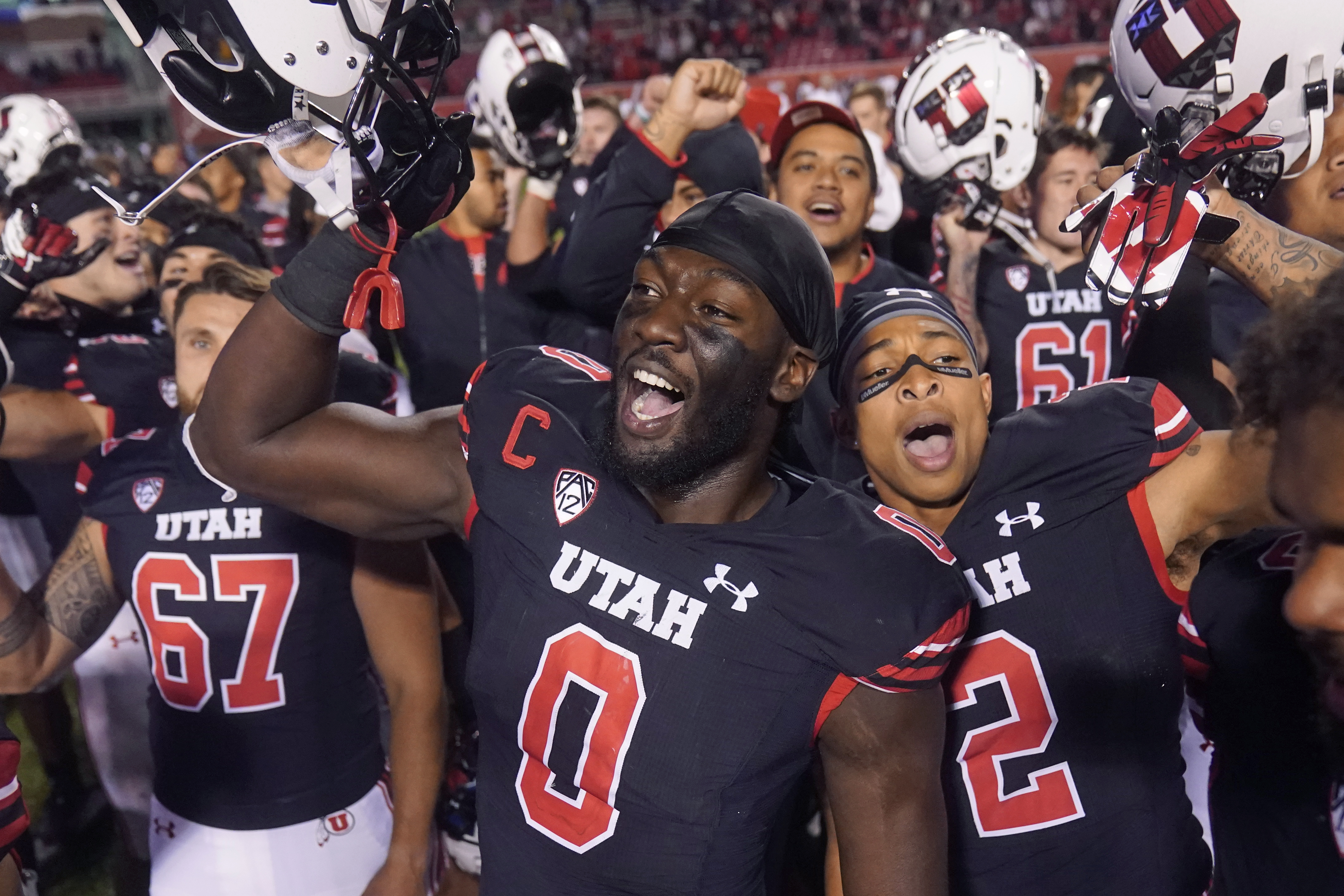 Utah linebacker Devin Lloyd (0) celebrates with teammates following an NCAA college football game against Arizona State on Oct. 16, 2021, in Salt Lake City.