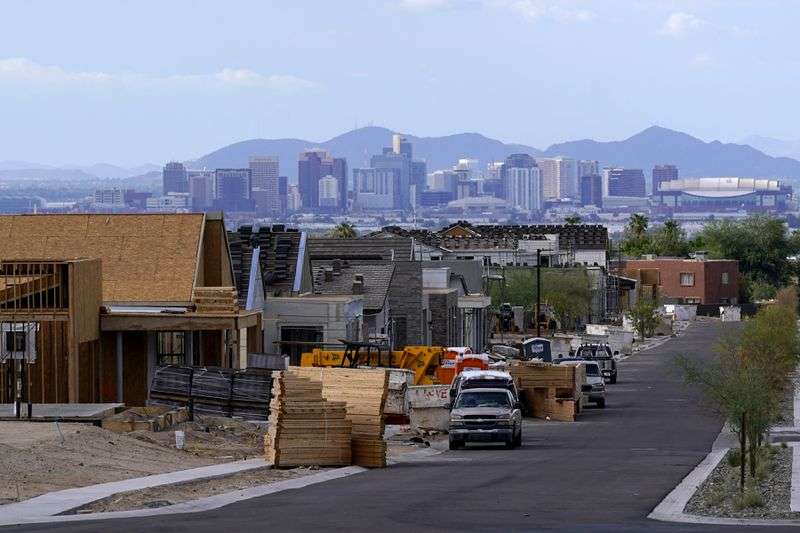 With the downtown Phoenix skyline in the background on Aug. 12, a
new housing development adds to the expansive urban sprawl that
continues to grow.