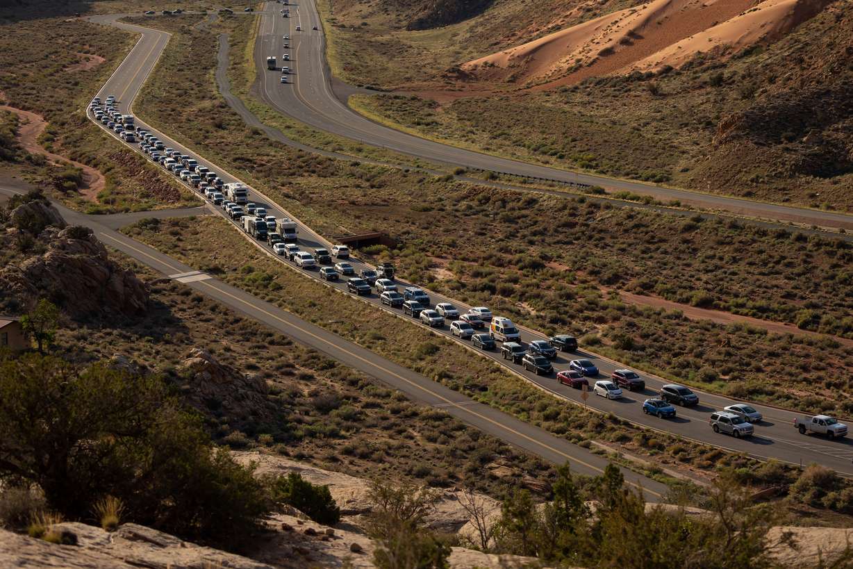 The entrance road to Arches National Park outside of Moab begins to back up with visitors on Sept. 19.