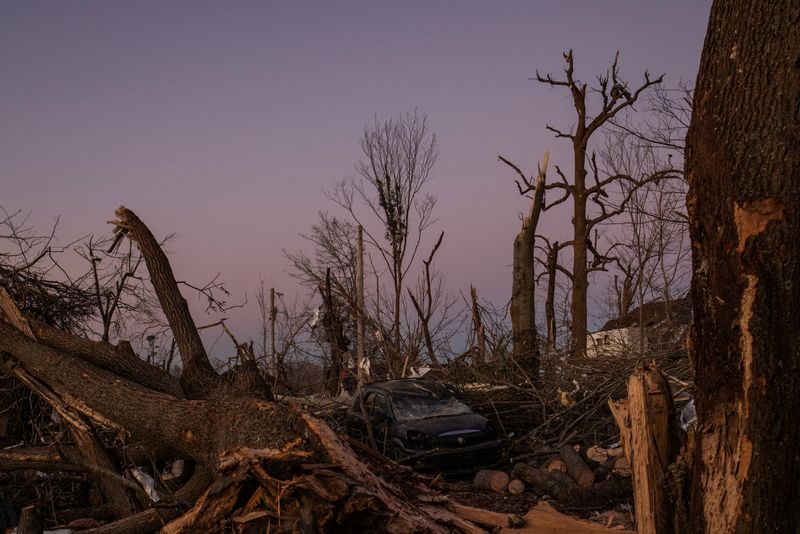A destroyed vehicle sits in the aftermath of a tornado in Mayfield, Kentucky, Monday. Tornadoes killed at least 74 people in Kentucky, officials said on Monday.