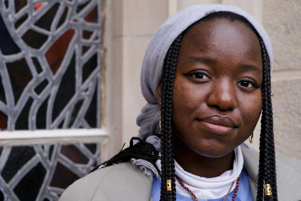 Nathalie Charles poses for a portrait outside the Princeton University Chapel in Princeton, N.J. on Wednesday, Dec. 8, 2021. The 18-year-old freshman at Princeton had identified as atheist, and then agnostic, before embracing a spiritual but not religious life.