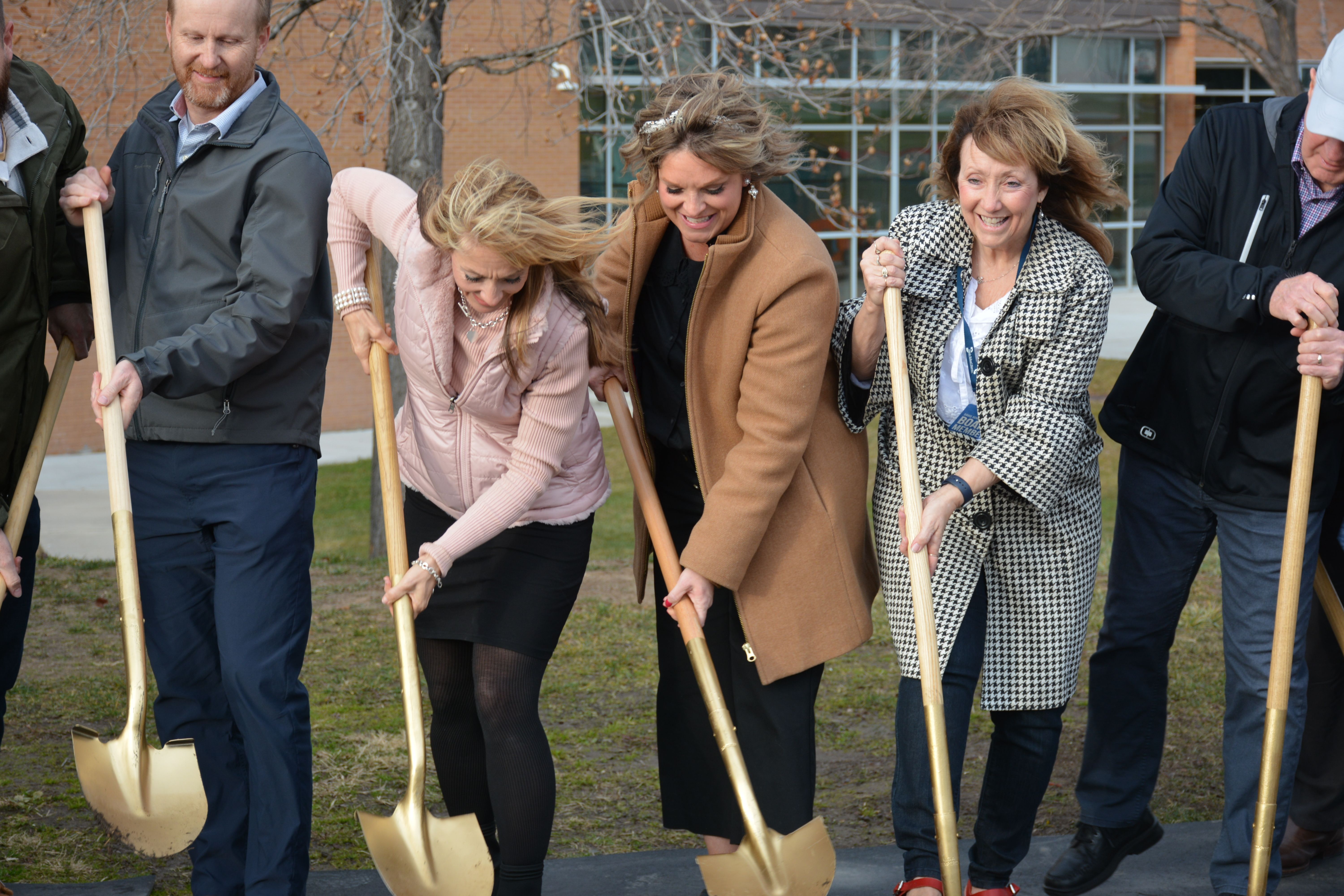Andrew Bollschweiler, Jodi Lunt, Jenny Freeman, Brigit Gerrard and John Robison break ground on the Woods Cross Teen Center on Tuesday. The center will serve as a safe haven for students experiencing homelessness or those that might have unstable home lives.