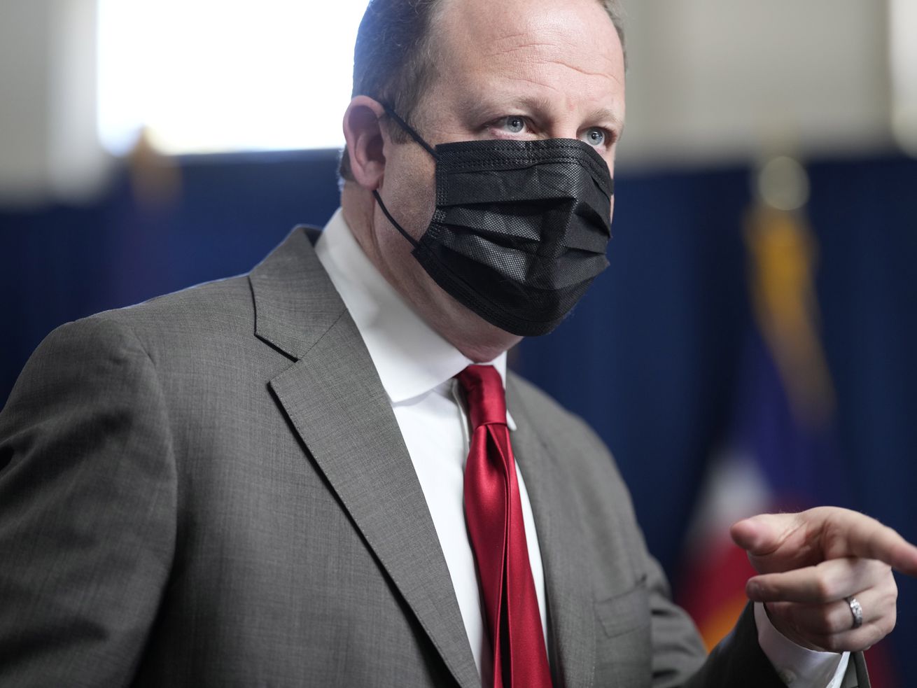 Colorado Gov. Jared Polis wears a face covering as he
speaks during a news conference on the state’s response to the
COVID-19 pandemic, Tuesday, Dec. 7, 2021, in Denver. Polis recently
said the COVID-19 emergency is "over.”