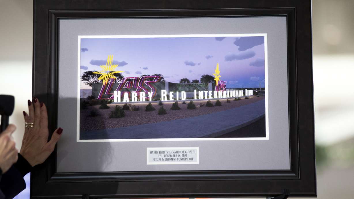 Clark County Director of Aviation Rosemary Vassiliades presents a framed illustration of proposed airport signage during the official renaming of McCarran International Airport to Harry Reid International Airport at the airport in Las Vegas on Dec. 14.