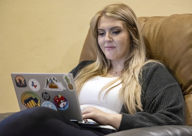 Alexa Minson reads homework on her computer as she
poses for photos at her home in Orem on Tuesday, Nov. 2.