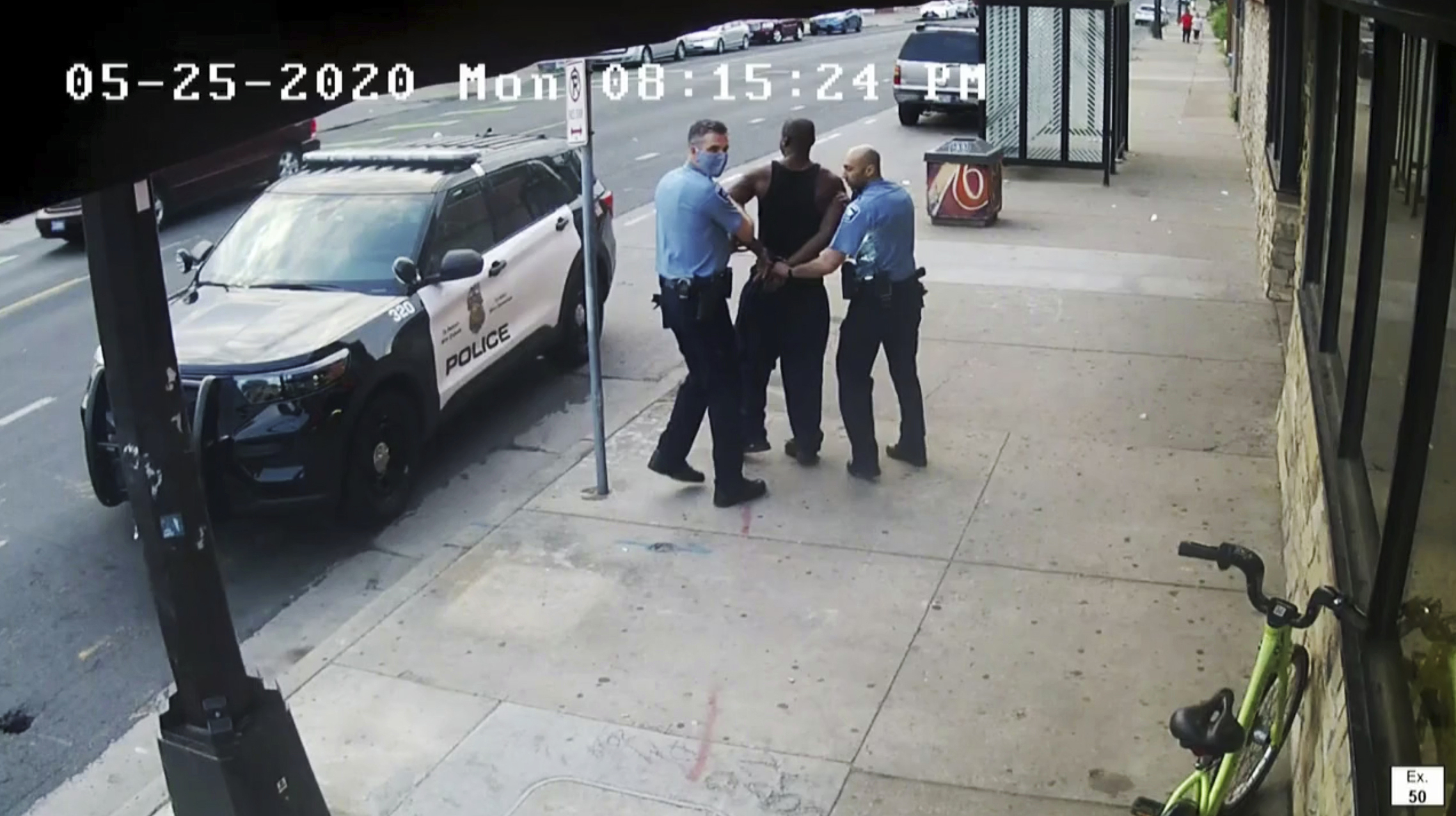 This image from video shows Minneapolis police Officers Thomas Lane, left and J. Alexander Kueng, right, escorting George Floyd, center, to a police vehicle outside Cup Foods in Minneapolis, on May 25, 2020.