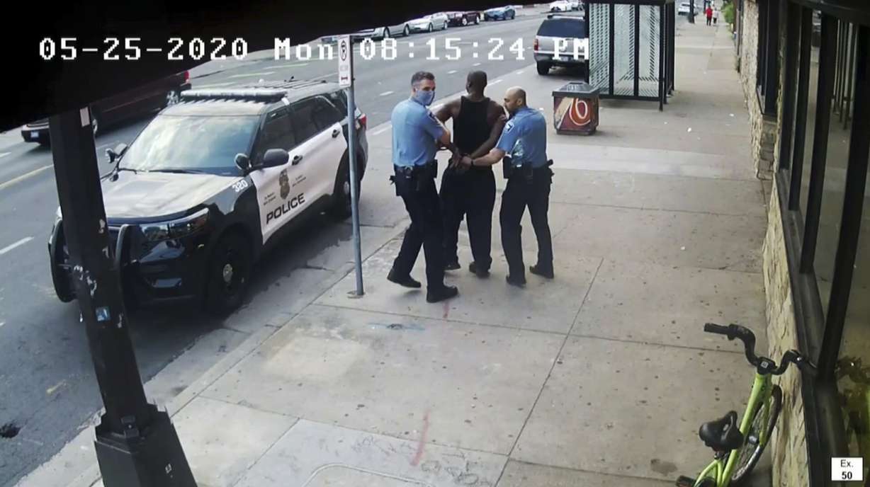 This image from video shows Minneapolis police Officers Thomas Lane, left and J. Alexander Kueng, right, escorting George Floyd, center, to a police vehicle outside Cup Foods in Minneapolis, on May 25, 2020.