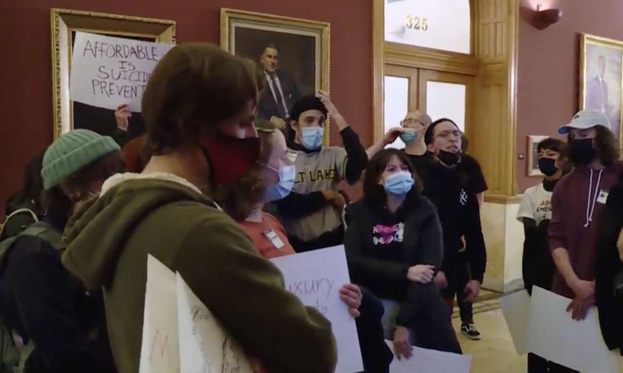 Protesters chat outside the Salt Lake City Council chamber Tuesday night. About two dozen were asked to leave after the meeting was disrupted.