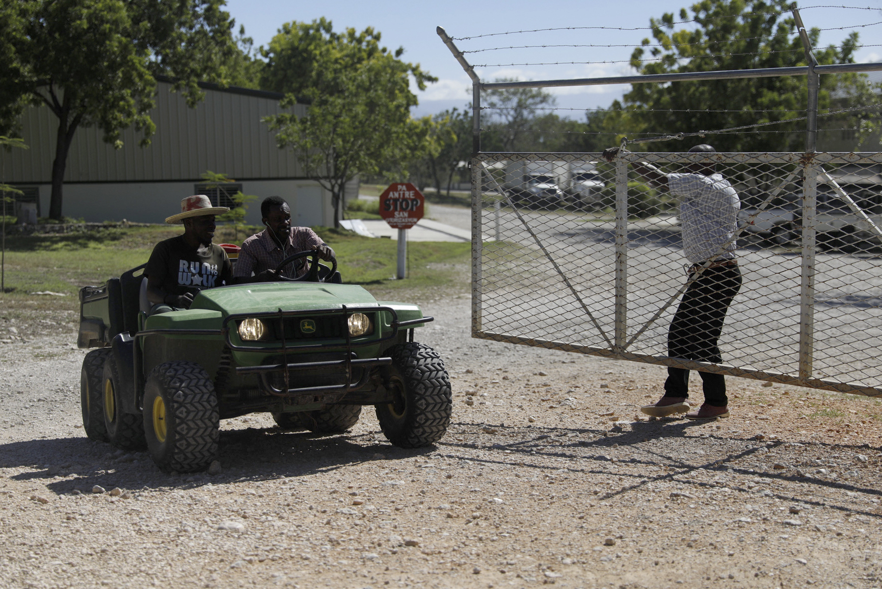 Workers ride out of the gate of the Christian Aid Ministries headquarters in Titanyen, north of Port-au-Prince, Haiti, Dec. 6. All members of a missionary group who were kidnapped have been freed, Haiti police said Thursday.
